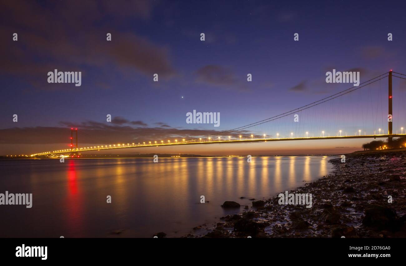 Night view of the Humber Bridge with lights reflected in the still water of the Humber estuary Stock Photo