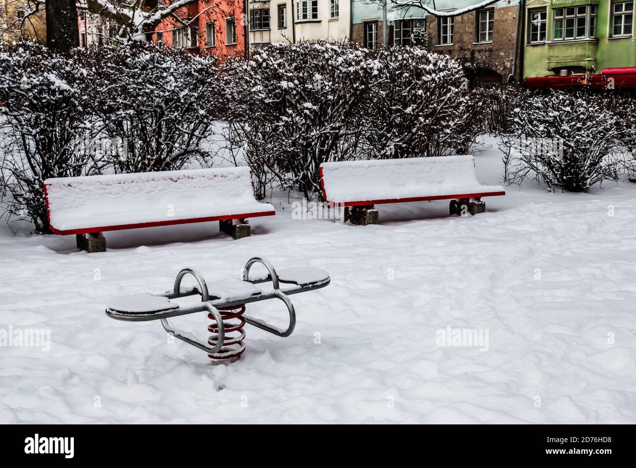 Two red benches at the children playground covered by snow Stock Photo