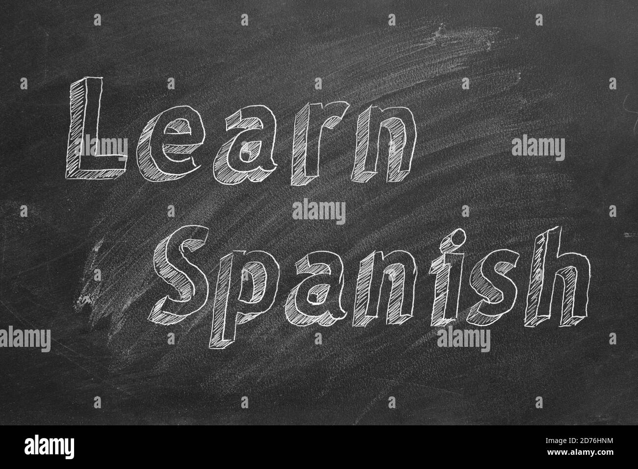 Hand drawing 'Learn Spanish' on blackboard Stock Photo