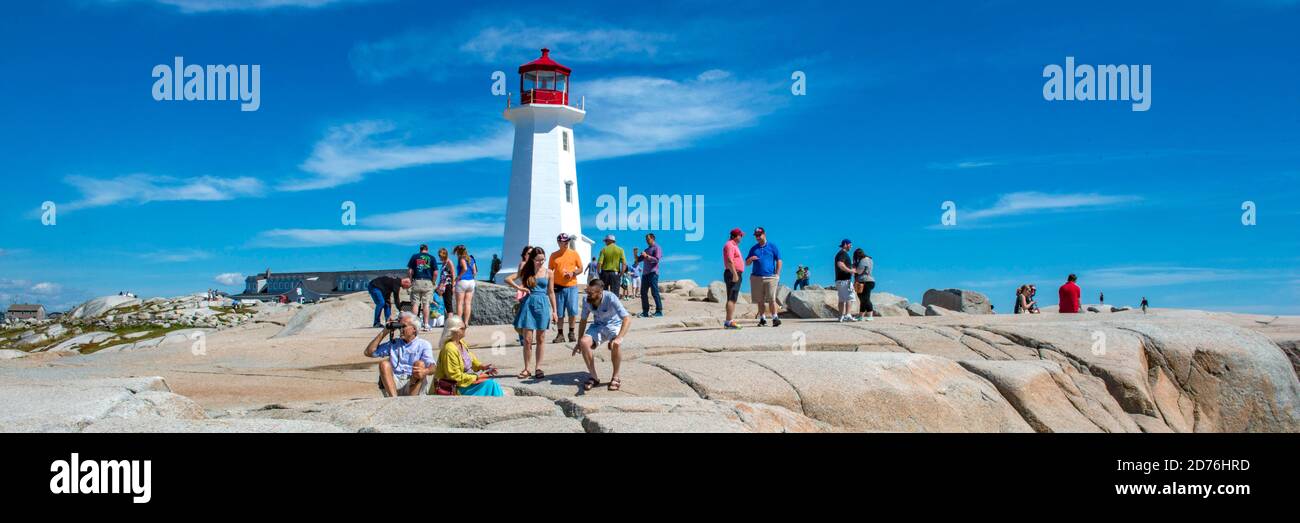 PEGGY'S COVE, NOVA SCOTIA, CANADA. 09-04-2014. Tourists enjoying a sunny autumn day at the famous lighthouse Stock Photo