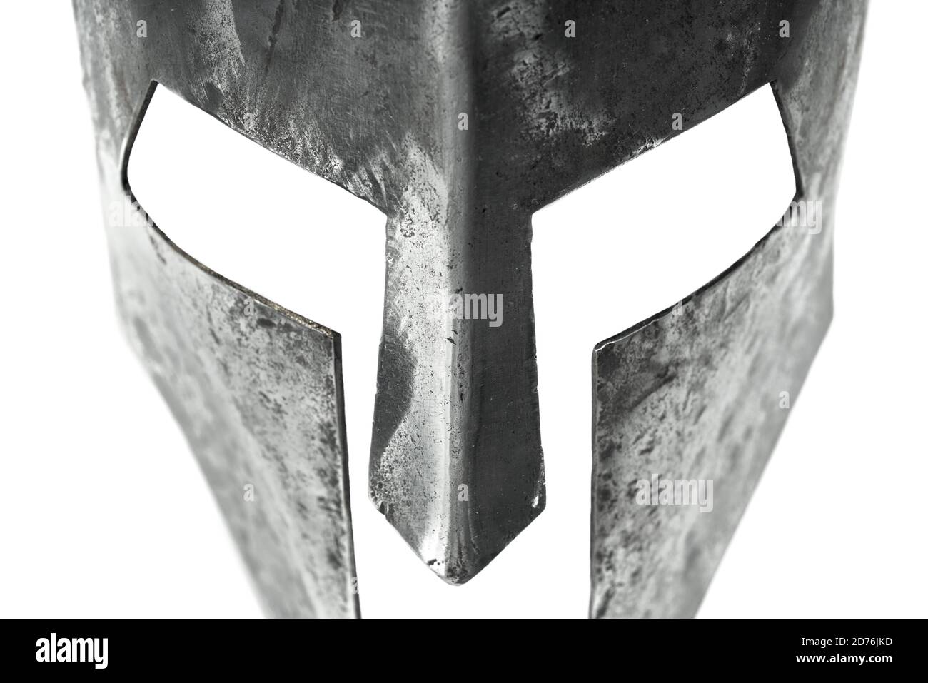 Closeup view of ancient iron spartan helmet isolated on white studio background. Medieval armor, archeological souvenir from past, metal tough head protection. Stock Photo