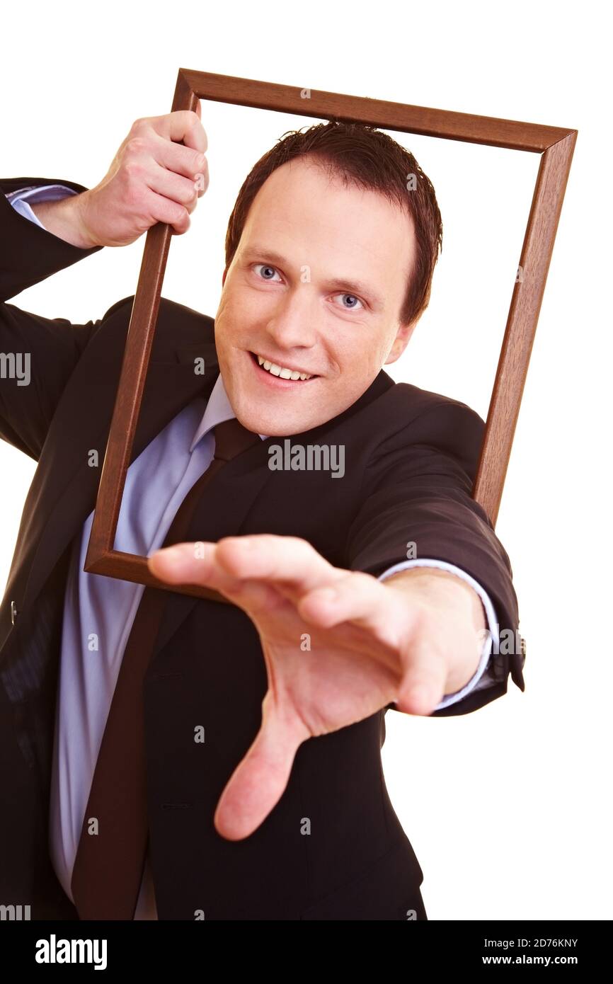 Businessman reaching through an empty wooden frame Stock Photo Alamy