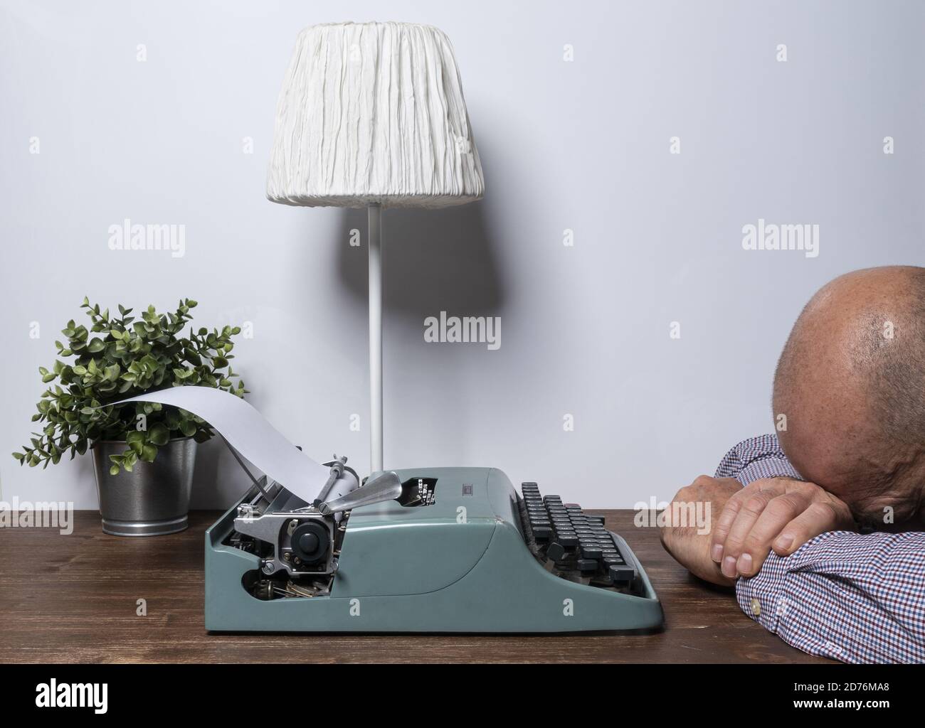 the desperation of a man who cannot find the words to write Stock Photo