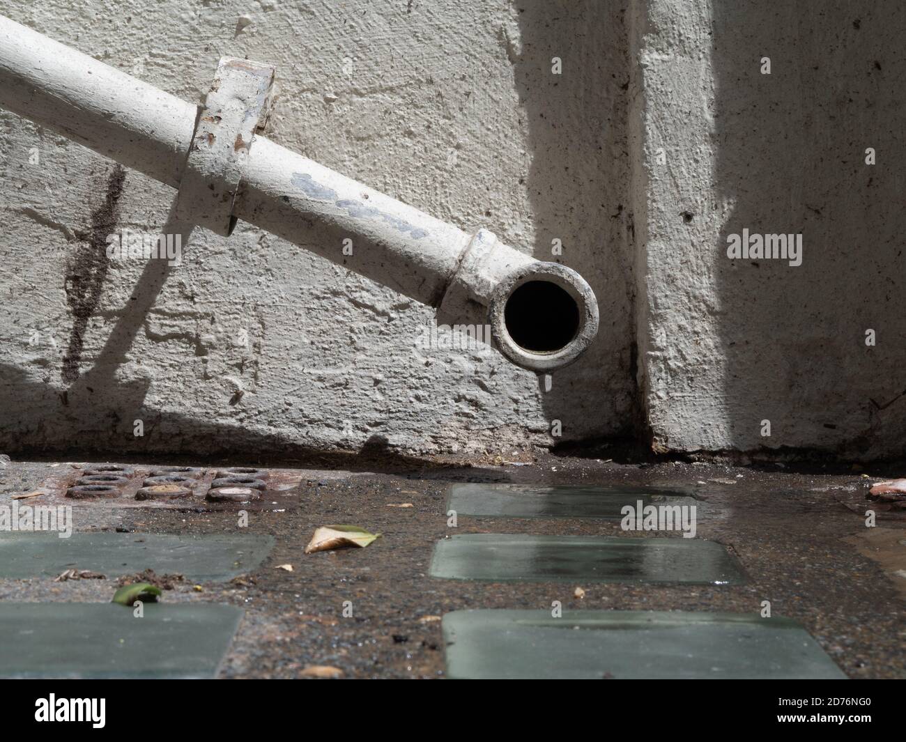 external dripping small drain pipe in the street of London Stock Photo