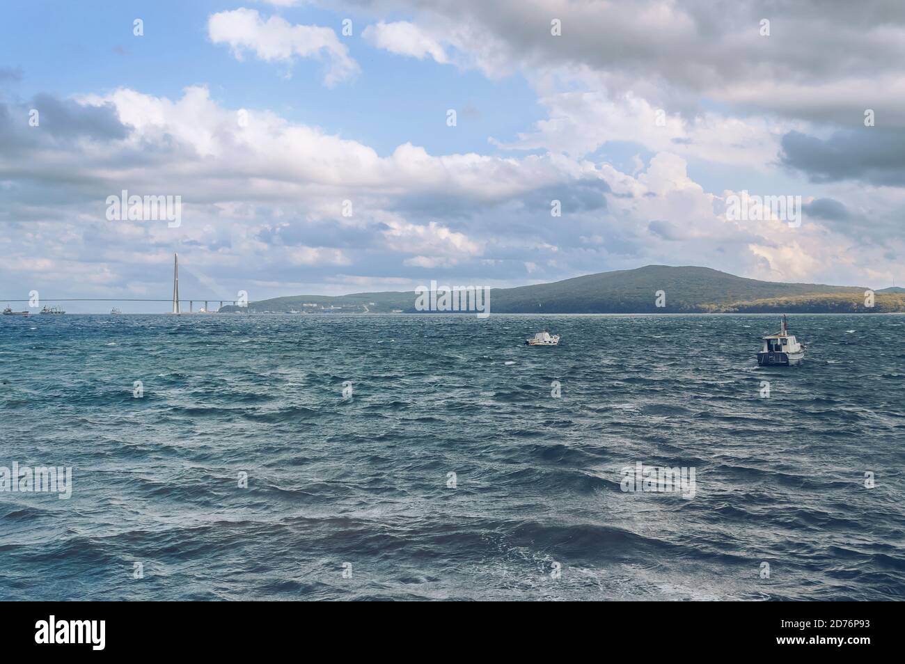 restless sea with boats,part of  Russkiy bridge and russkiy island on background Stock Photo