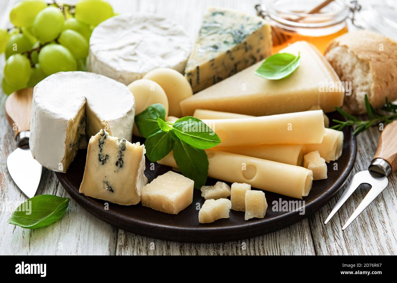 Various types of cheese  on a white wooden background Stock Photo