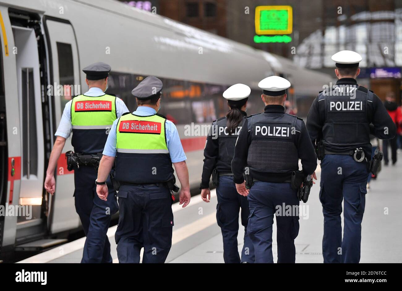 Leipzig, Germany. 21st Oct, 2020. Federal police officers and DB Sicherheit employees walk along the ICE 602 from Munich to Hamburg after checking that hygiene rules are being observed - in particular that nose-mouth covers are worn. According to Deutsche Bahn, prevention and control measures are regularly carried out in trains and stations throughout Germany with the support of the Federal Police. Credit: Martin Schutt/dpa-Zentralbild/dpa/Alamy Live News Stock Photo