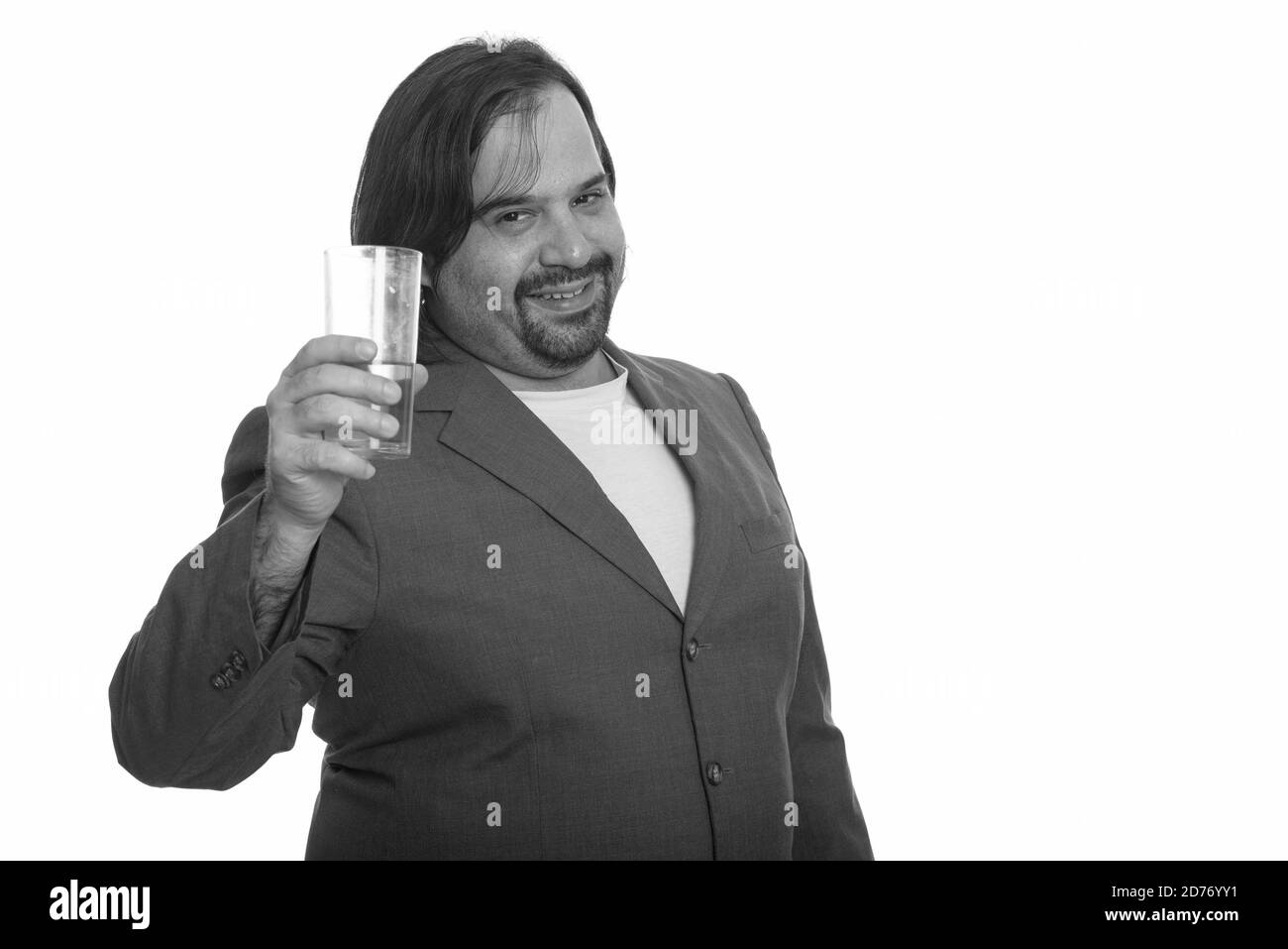 Happy fat Caucasian businessman smiling and holding glass of beer Stock Photo