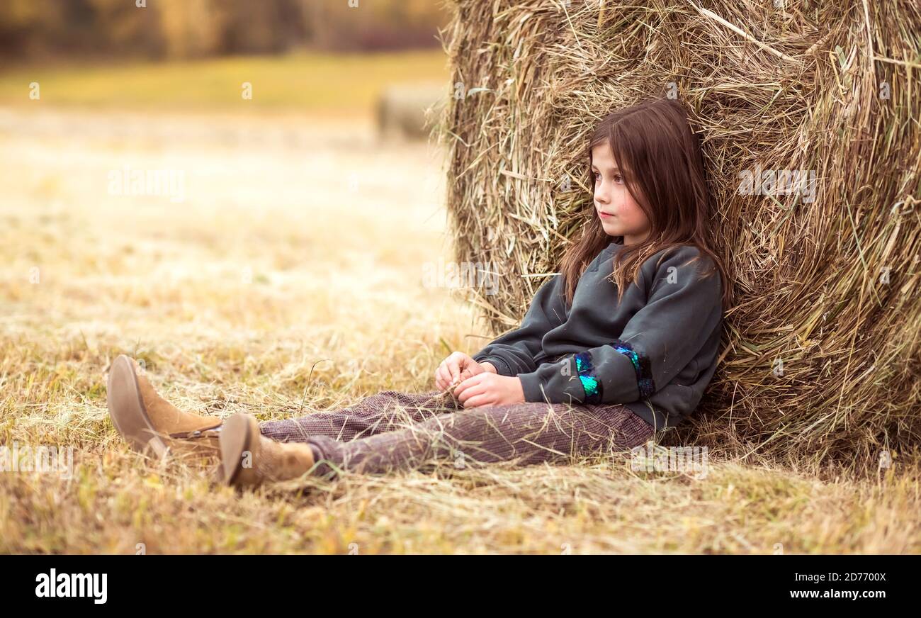 Sad girl sitting grass hi-res stock photography and images - Alamy