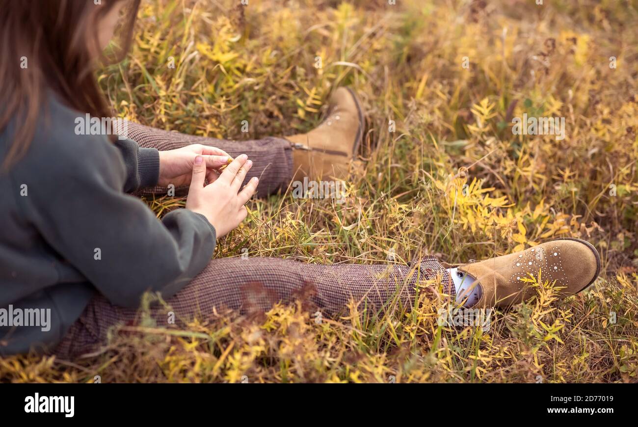 Sad girl sitting grass hi-res stock photography and images - Alamy