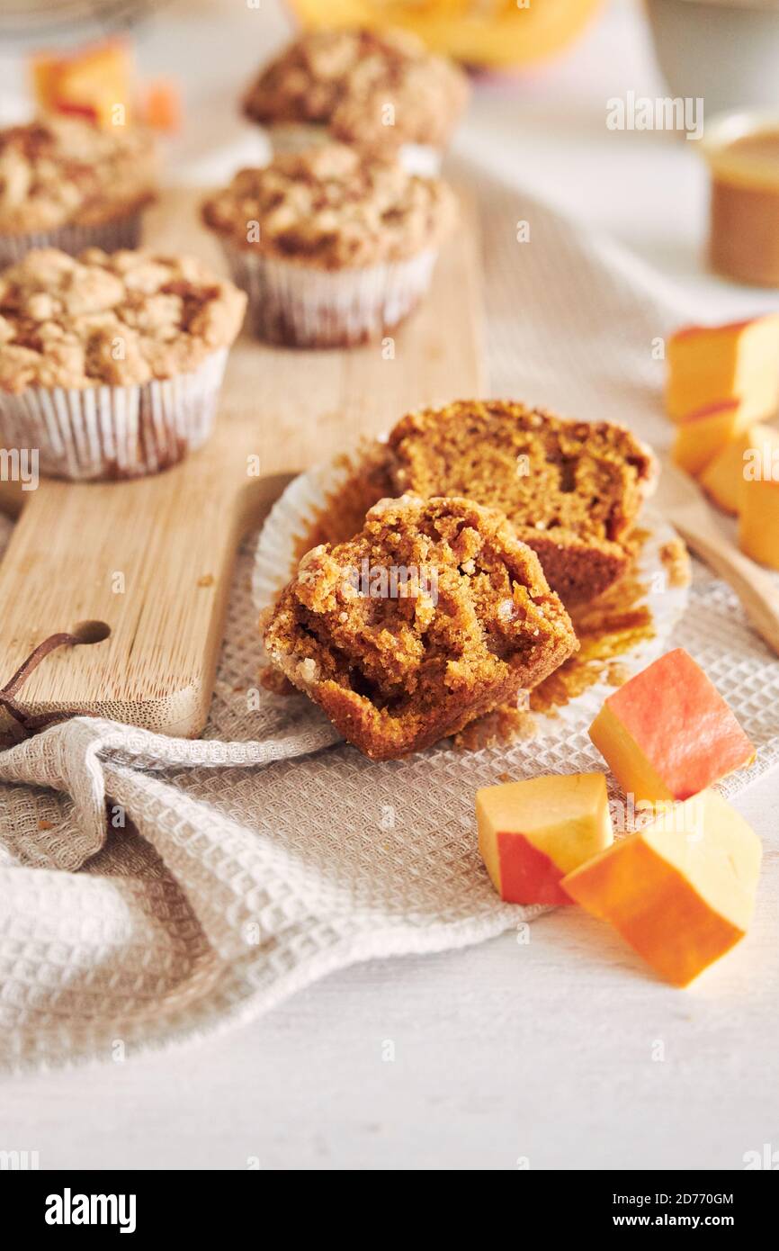 Homemade pumpkin pie muffins with cinnamon on a wooden board Stock Photo