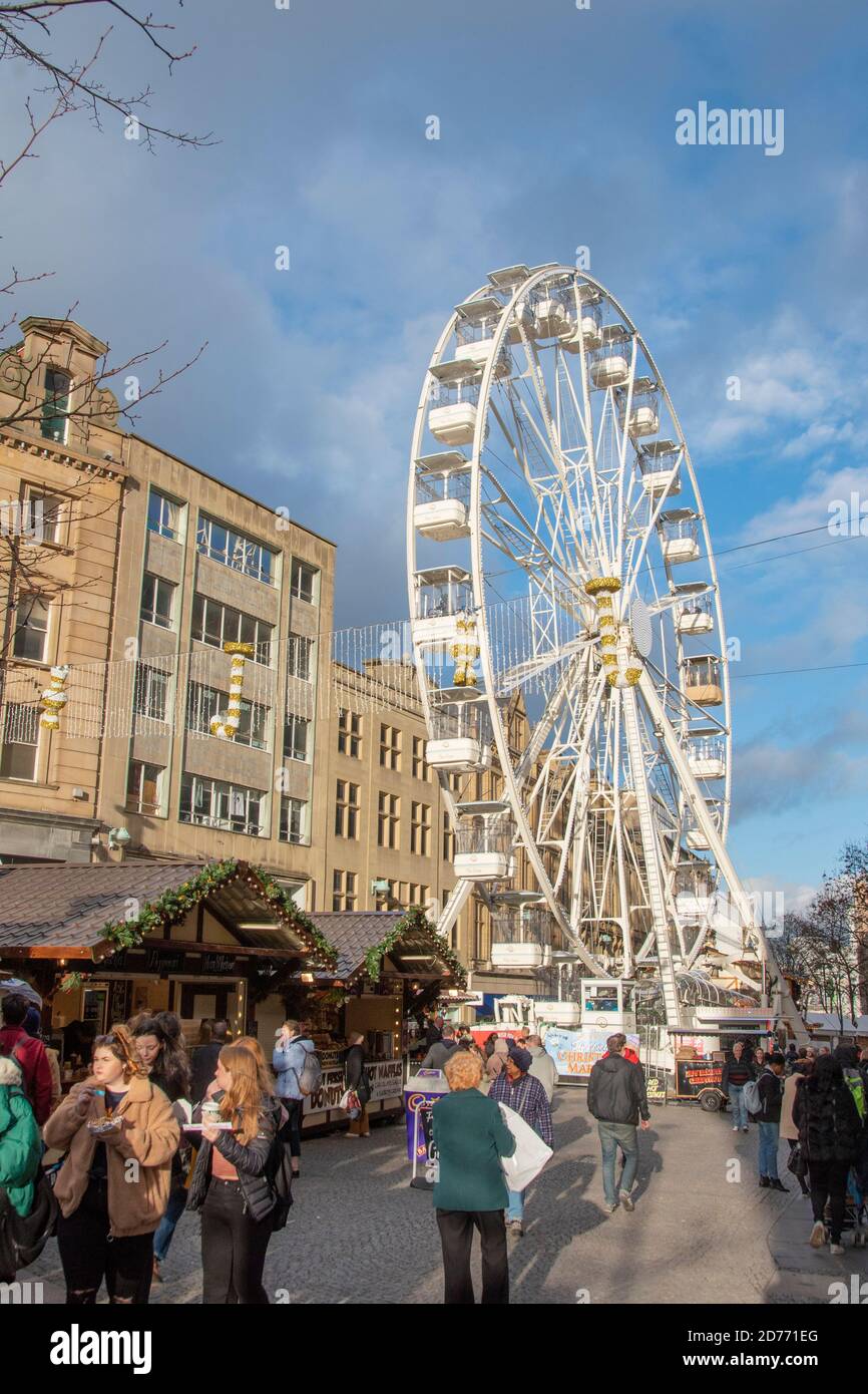 Sheffield,  UK – 30 Nov 2018 : Christmas shoppers visit the Christmas Market and ferris wheel on Fargate Stock Photo