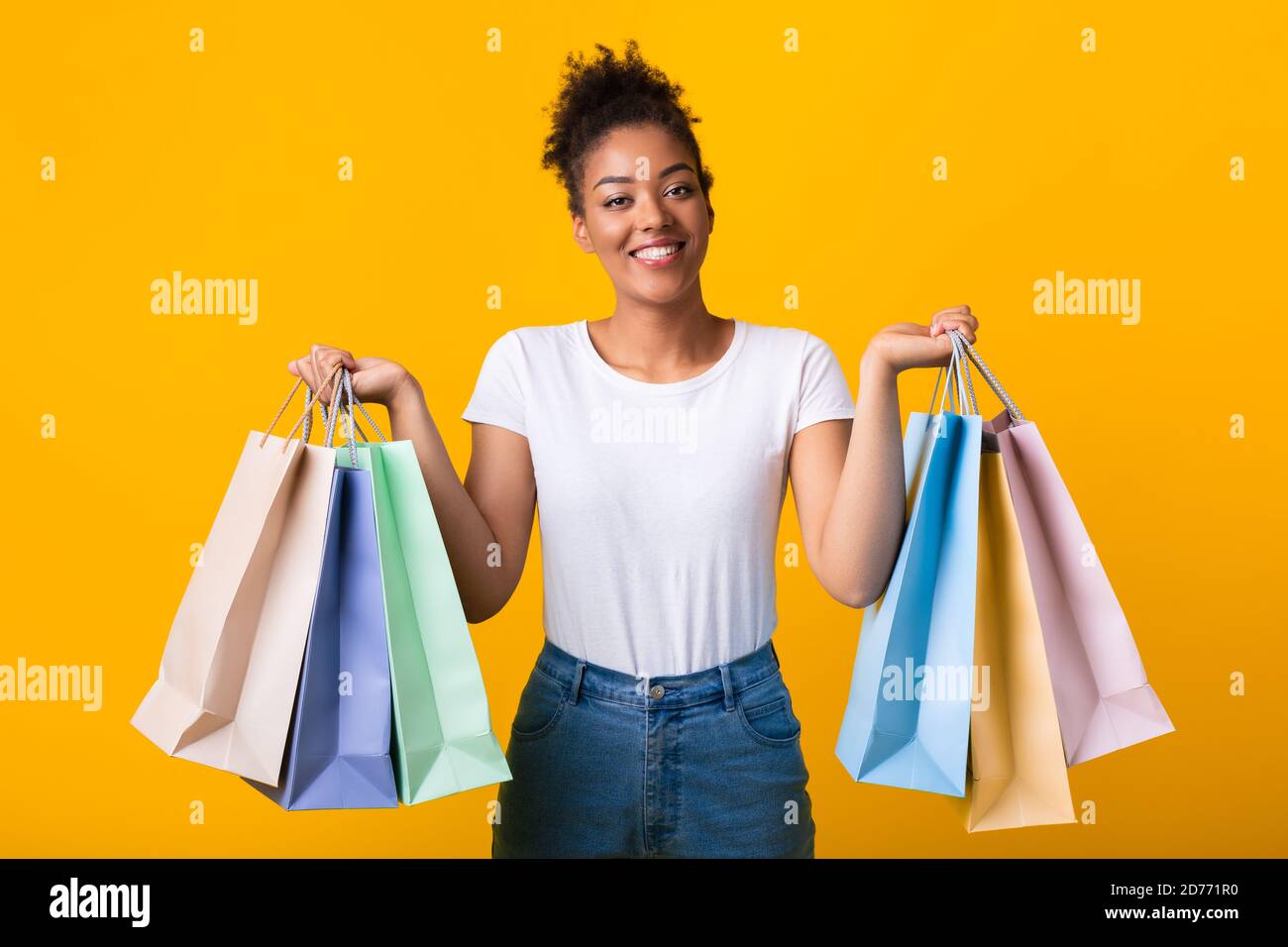 Portrait of cheerful black woman holding shopping bags Stock Photo - Alamy