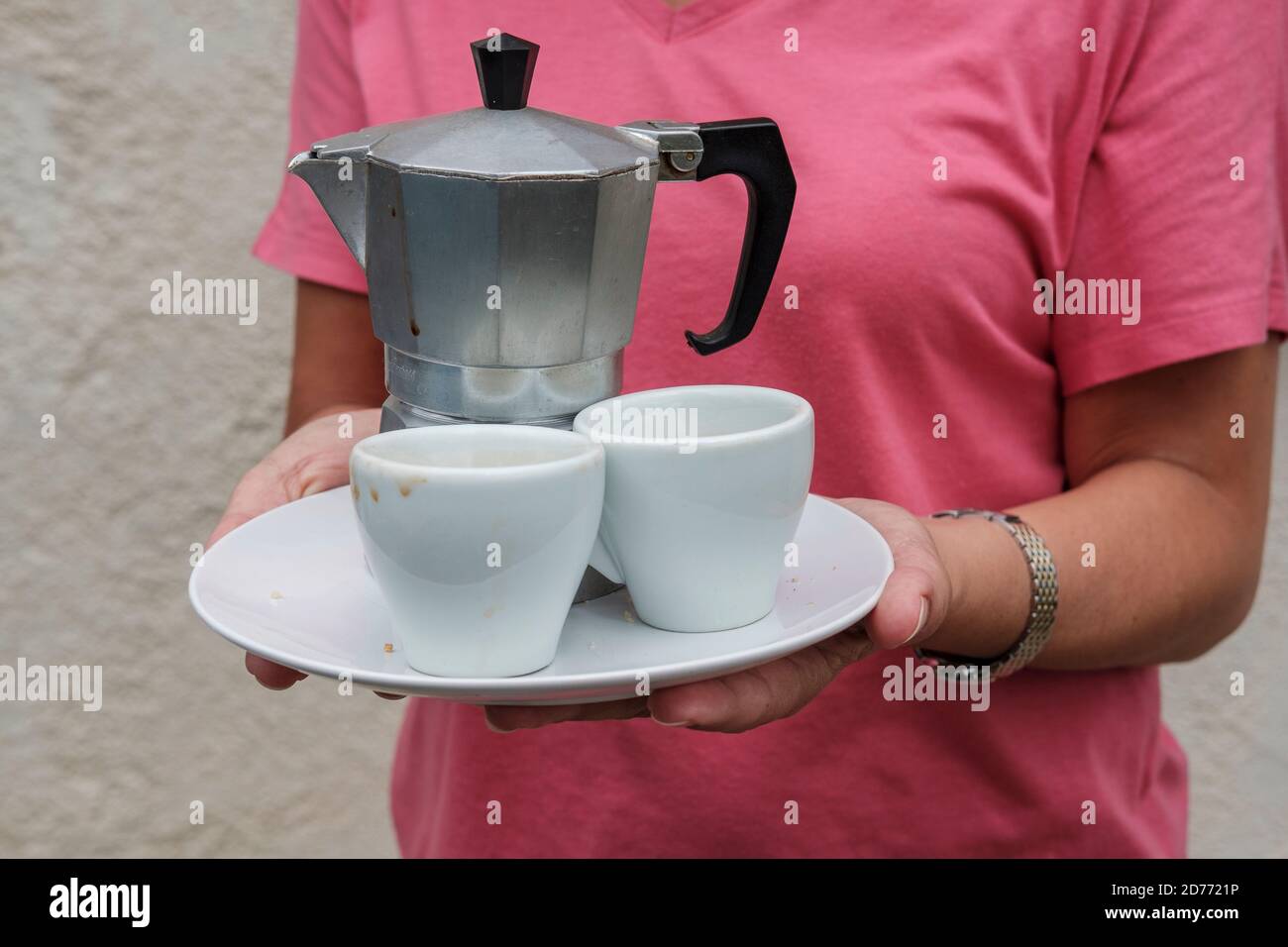 Coffee being served in a café with Bialetti espresso maker with two cups  and biscuit Stock Photo - Alamy