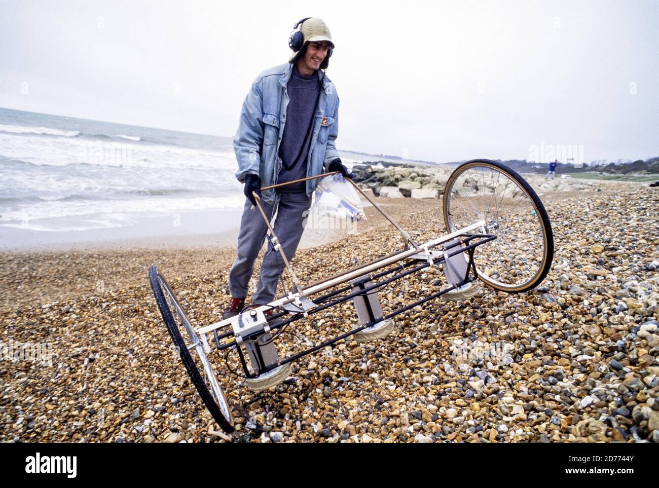 An oceanography student from Southampton University using a specially built evice to search for pebbles with transponders built into them as part of a project to map the patterns of long shore drift on the beach at Highcliffe on the south coast of England.. 08 March 1994. Photo: Neil Turner Stock Photo