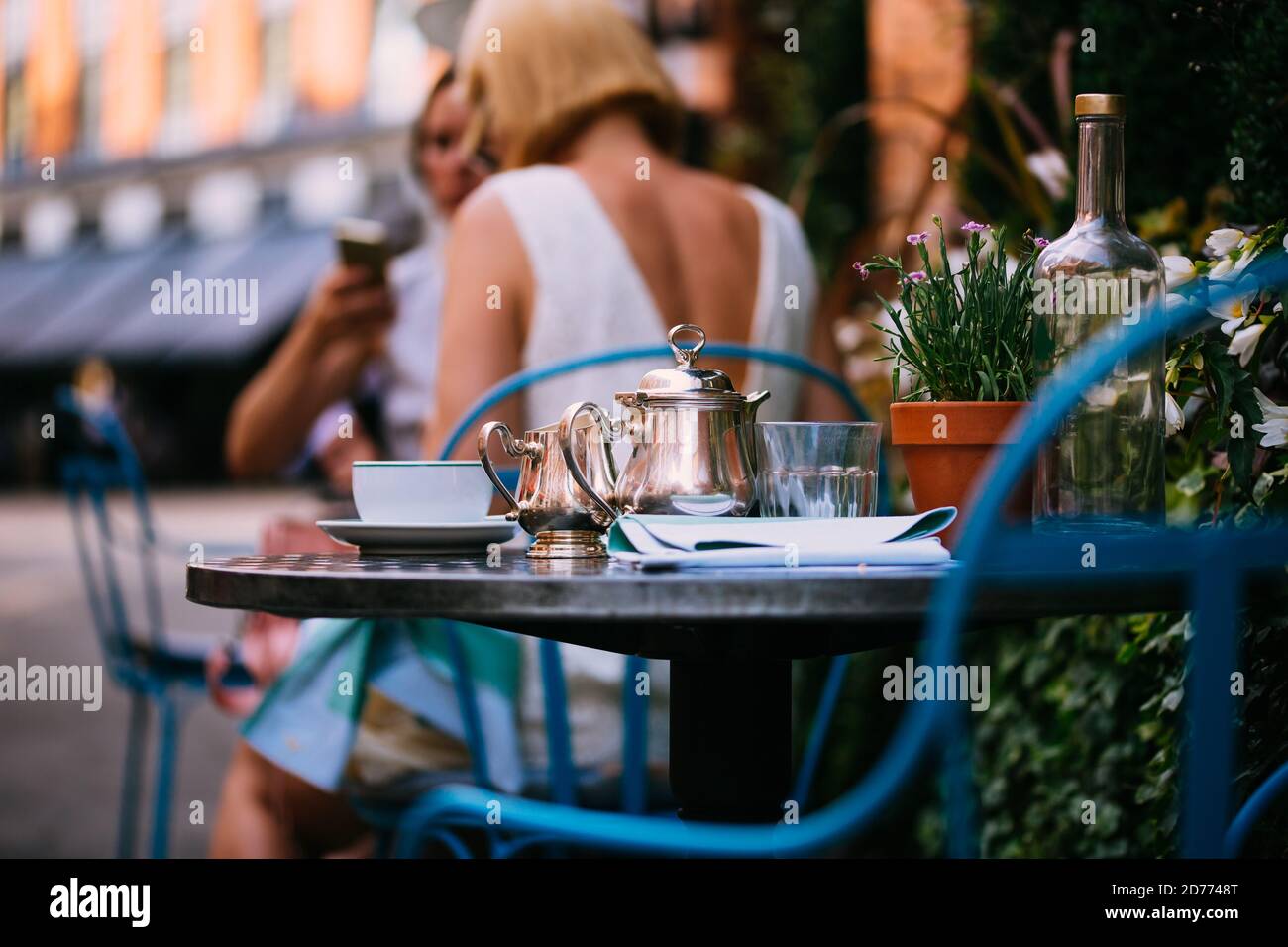 Outdoor luxury restaurant terrace, afternoon tea, tea pot on tables in