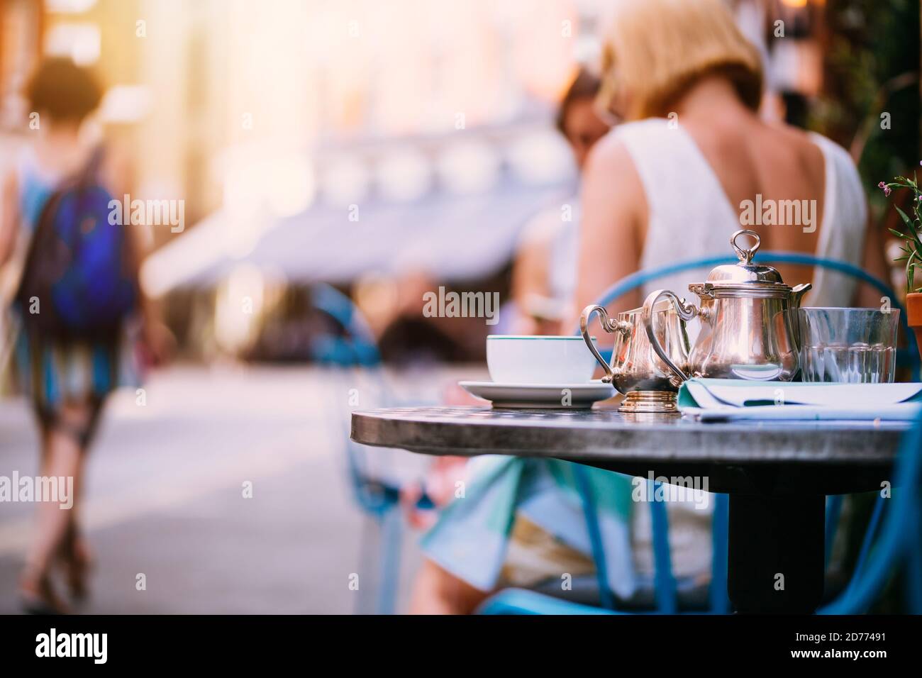 Outdoor luxury restaurant terrace, afternoon tea, tea pot on tables in