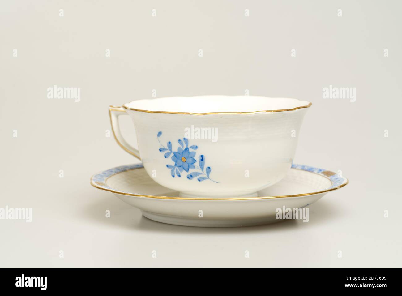 Cup and saucer on light background. Herend Porcelain Hungary Stock