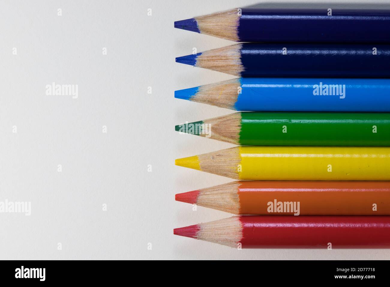 Coloured pencil crayons on a white background. Rainbow colours Stock Photo