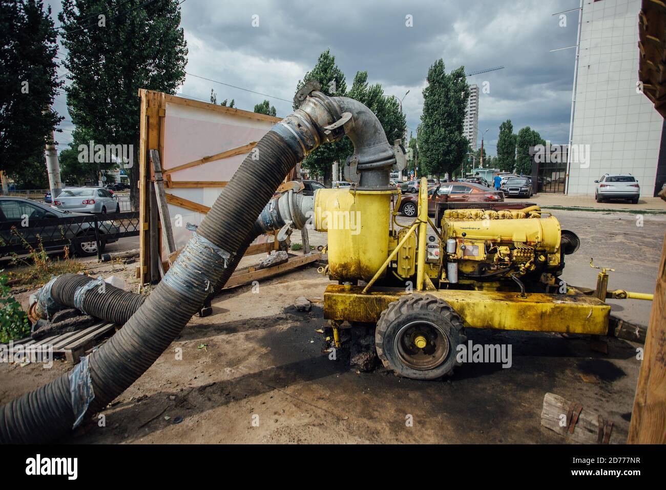 Cleaning sewer manholes by specialized pump machine on the street Stock Photo