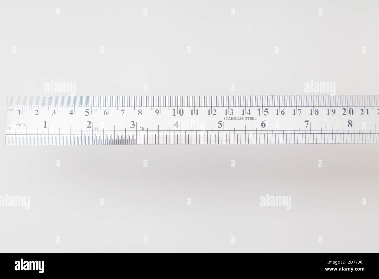 Stainless Steel Ruler With Inches And Centimeters On White Stock Photo stainless-steel-ruler-with-inches-and-centimeters-on-white-stock-photo