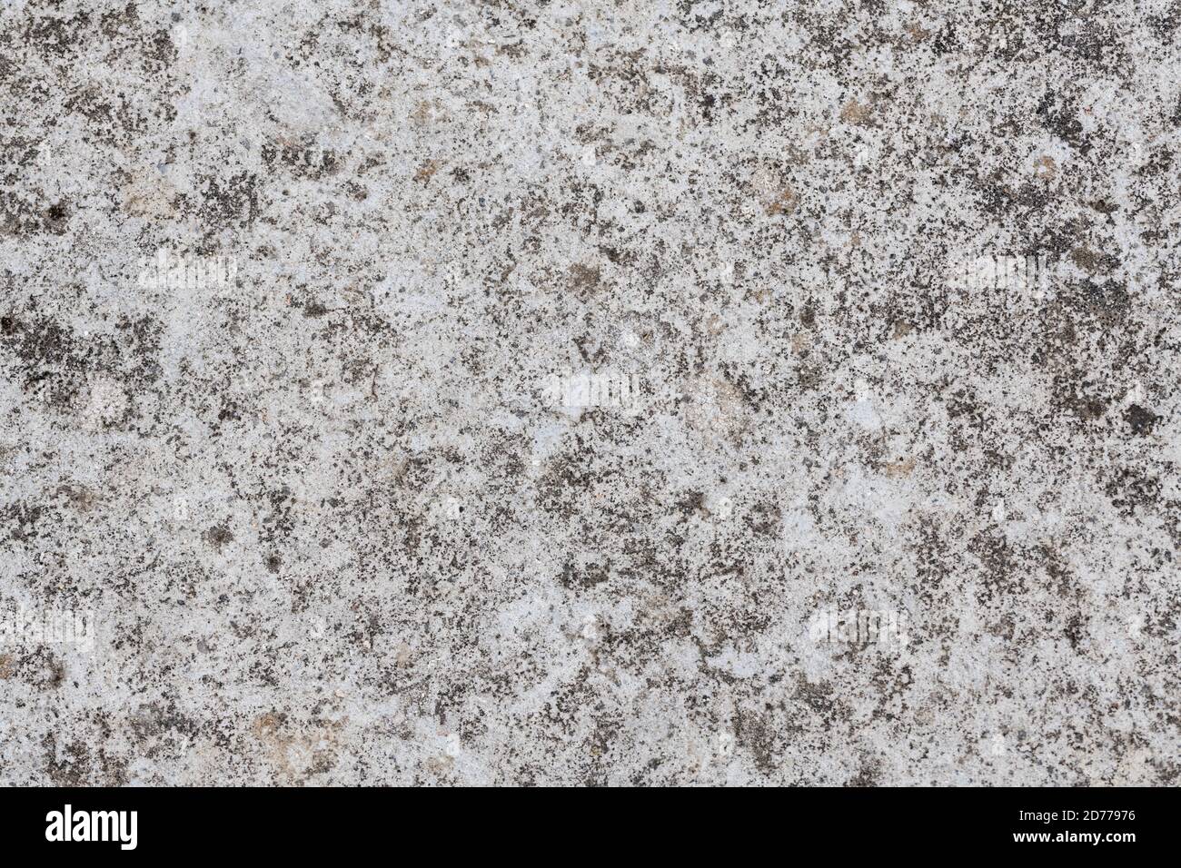 Smooth concrete cement surface stained by weathering mildews etc. Only laid down about 3 years ago. Gritty concrete surface texture. Stock Photo