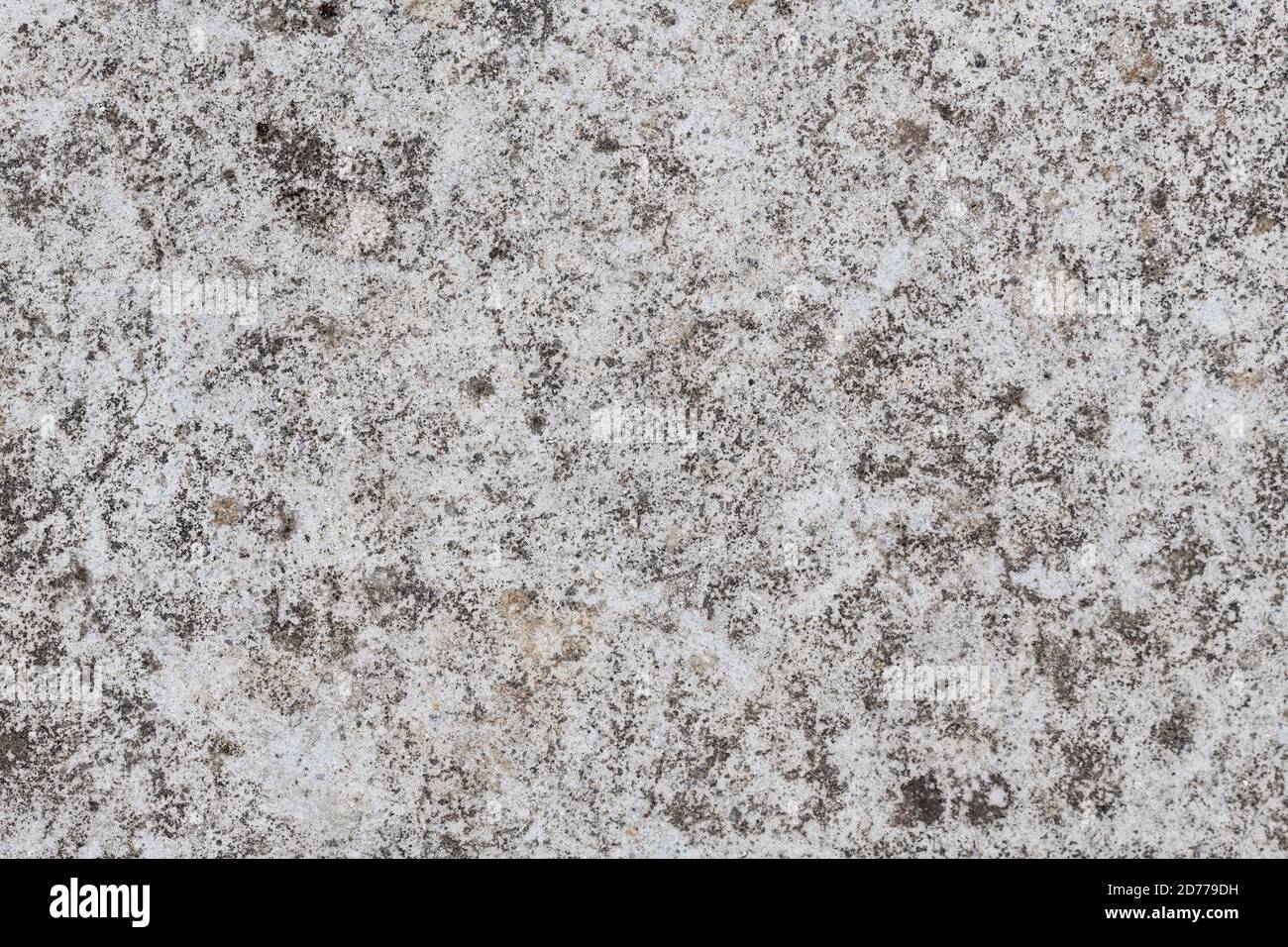 Smooth concrete cement surface stained by weathering mildews etc. Only laid down about 3 years ago. Gritty concrete surface texture. Stock Photo