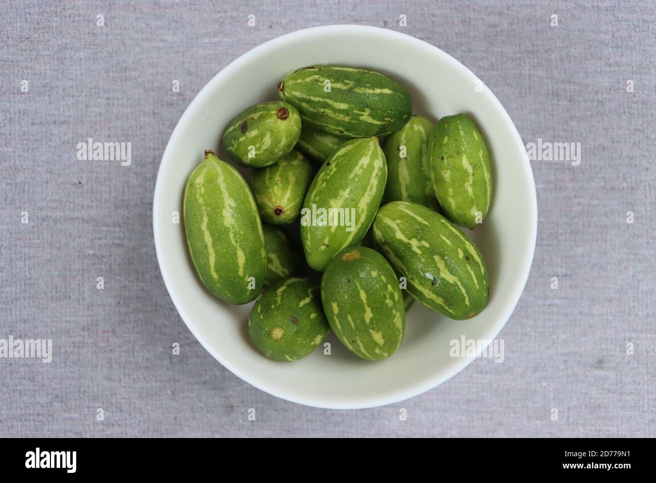 Ivy gourd or little gourds in white bowl Stock Photo