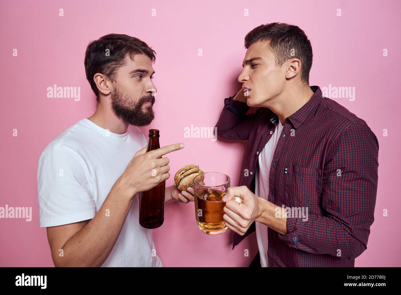 Two men drink beer friendship drunk alcohol lifestyle pink background Stock Photo Alamy