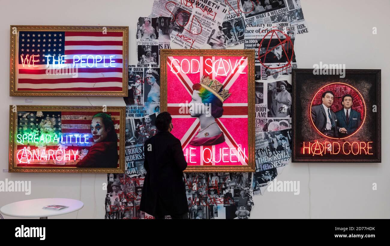 London, UK.  21 October 2020. A visitor views 'Rainbow Punk Queen (Neon)', 2020, 'Spread a Little Anarchy (Joker Neon)', 2020, and 'We The People', 2020, all by Mark Illuminati. Preview of STARTnet Art Fair at the Saatchi Gallery in Chelsea.  The contemporary art fair showcases local London, as well as international, galleries and individual artists from all over the world.  The fair runs 21 to 25 October with Covid-19 protocols in place for visitors.  Credit: Stephen Chung / Alamy Live News Stock Photo