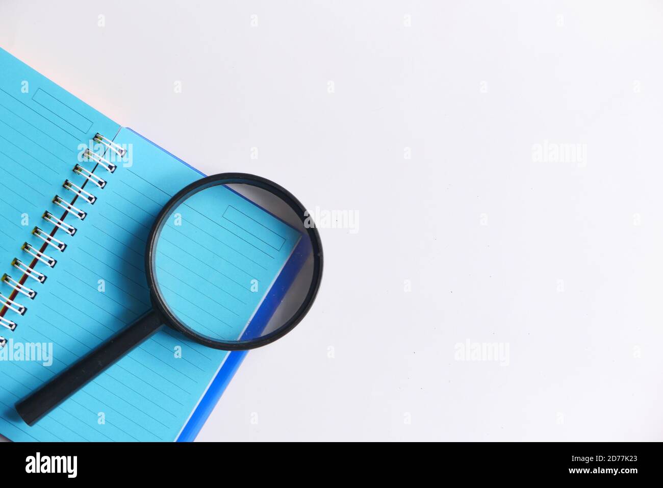 open book and magnifying glass on white background Stock Photo - Alamy