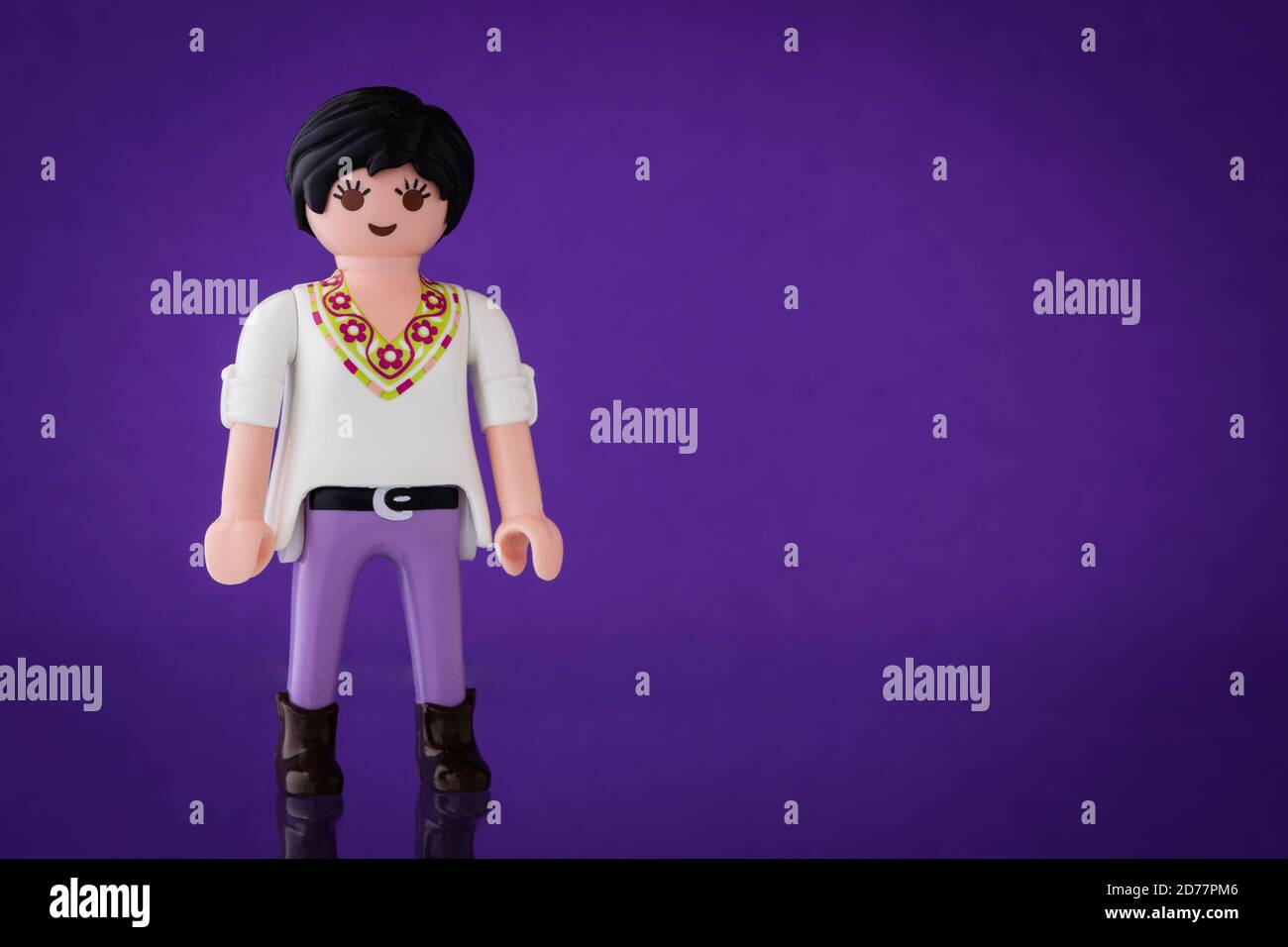 Minifigure in an outfit of purple clothing Stock Photo