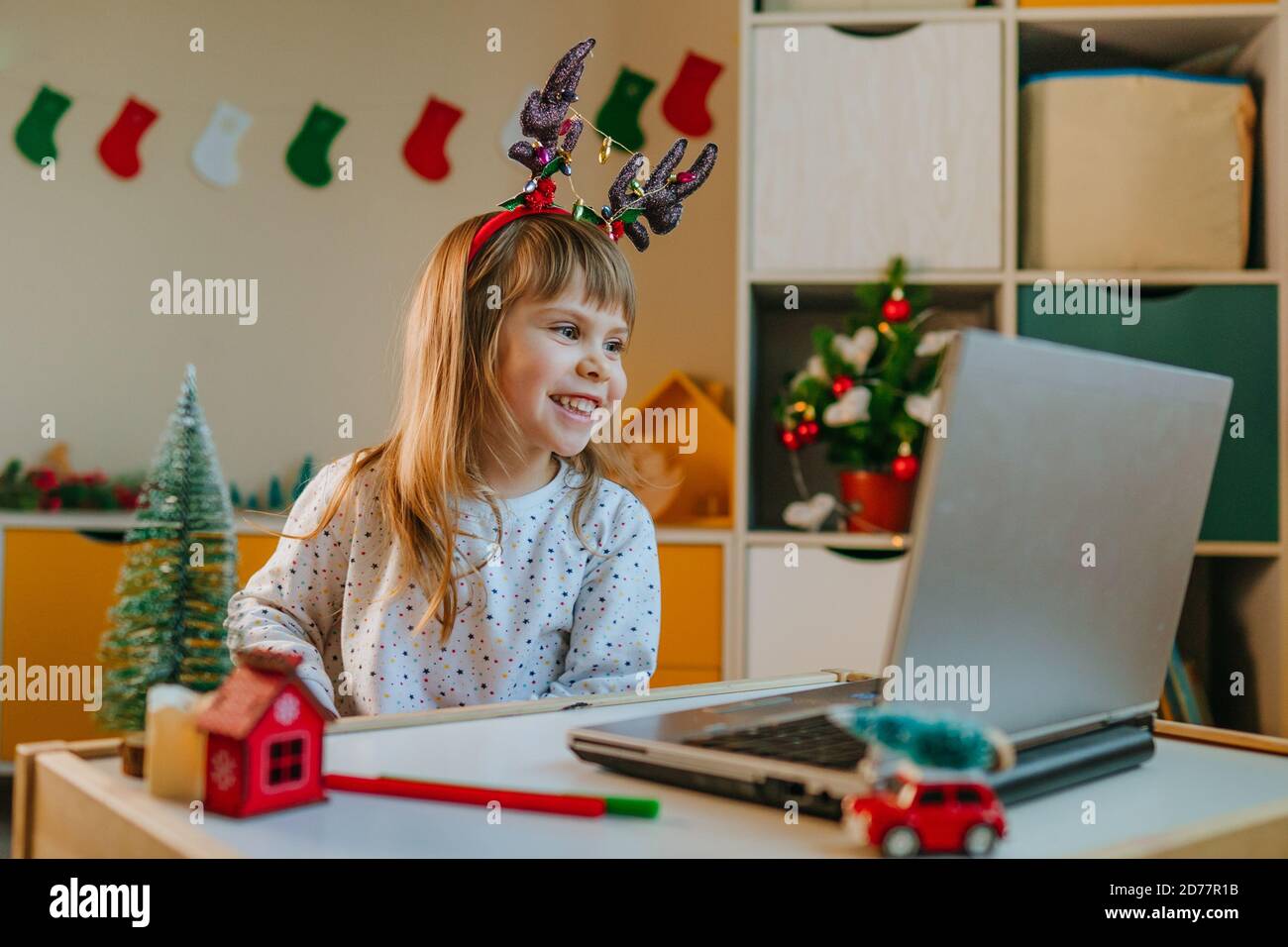 Girl making video call in Christmas time Stock Photo