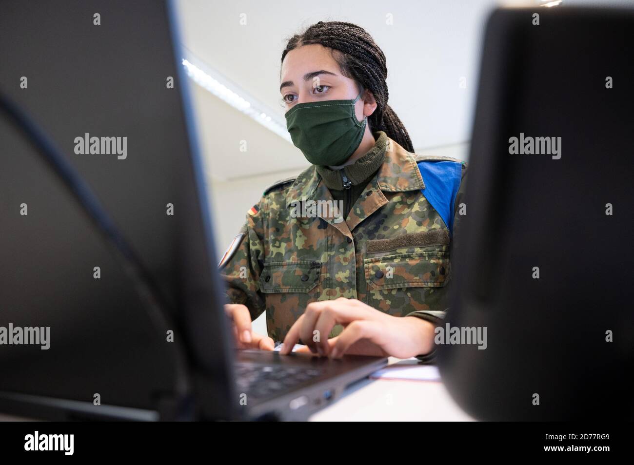 Stuttgart, Germany. 21st Oct, 2020. A female soldier of the Jägerbataillon 292 from Donaueschingen supports the public health department in a building of the city of Stuttgart in corona contact tracing. The public health authorities in Baden-Württemberg are increasingly looking for personnel to track infection chains. In the state capital, 60 soldiers of the Hunter Battalion are deployed. Credit: Marijan Murat/dpa/Alamy Live News Stock Photo