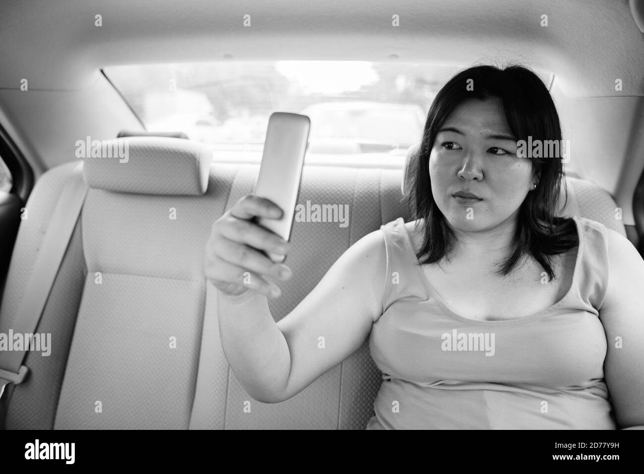 Beautiful overweight Asian woman inside the car around the city Stock Photo