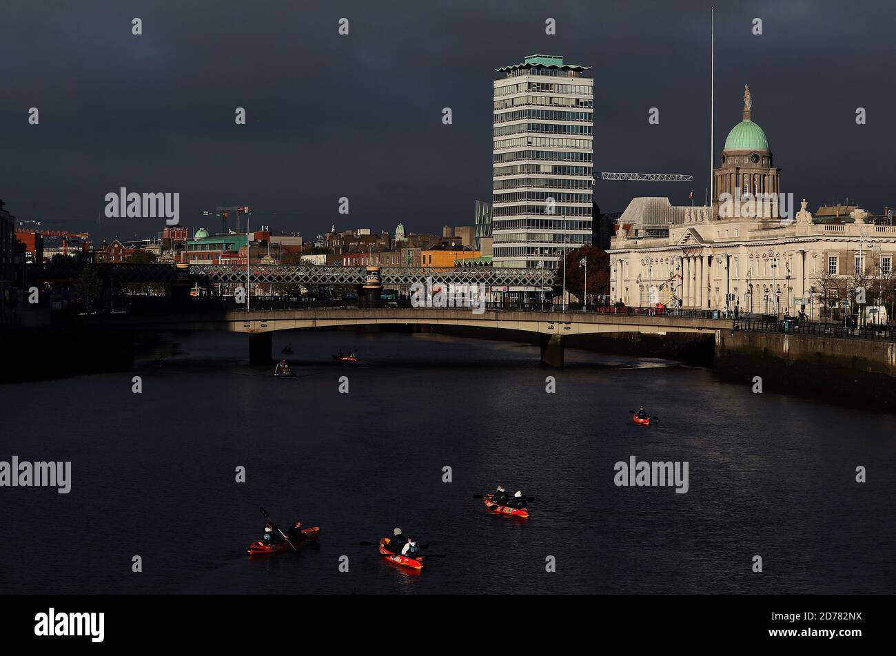 People canoe on the river Liffey in Dublin's city centre on an autumn ...