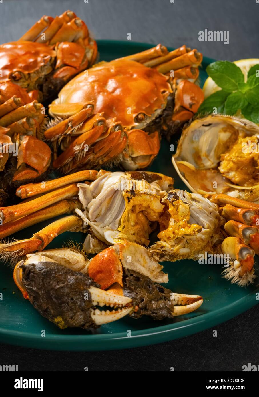 angle view crabs with one opened showing the crab roe and meat vertical