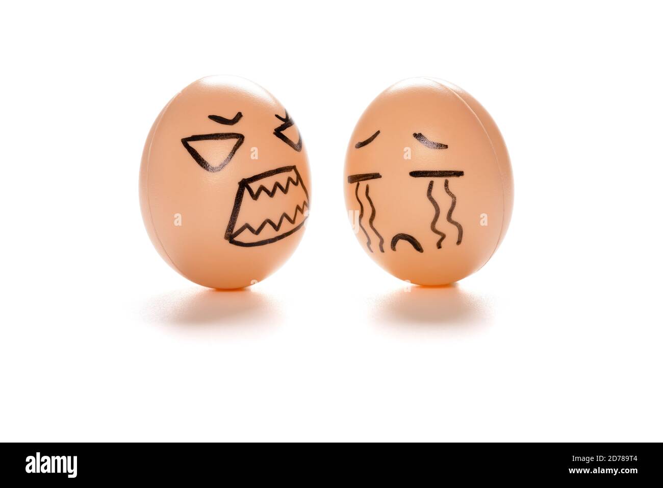 egg faces of an angry one blaming a crying one on white with clipping path Stock Photo