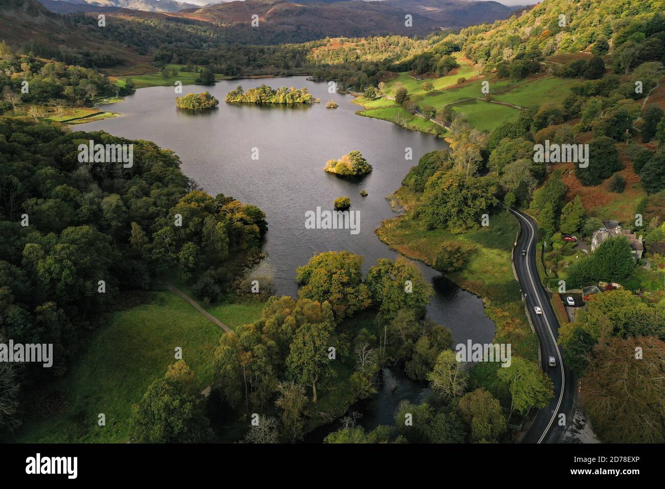 An aerial landscape by drone of Rydal Water lake towards Grasmere in the Lake District National Park, UK during Summer or Fall Stock Photo
