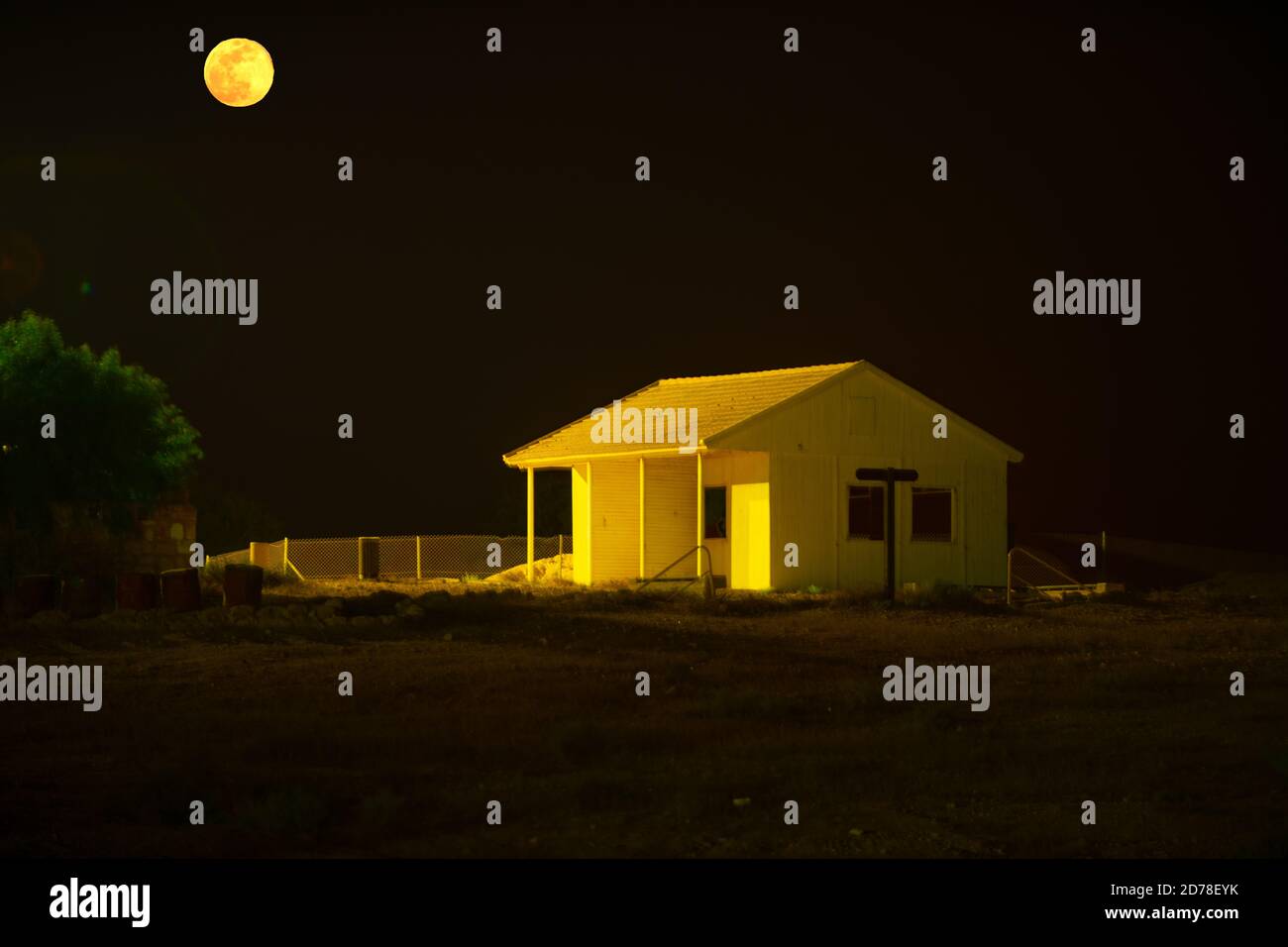 Moon lit remote cabin at night Stock Photo