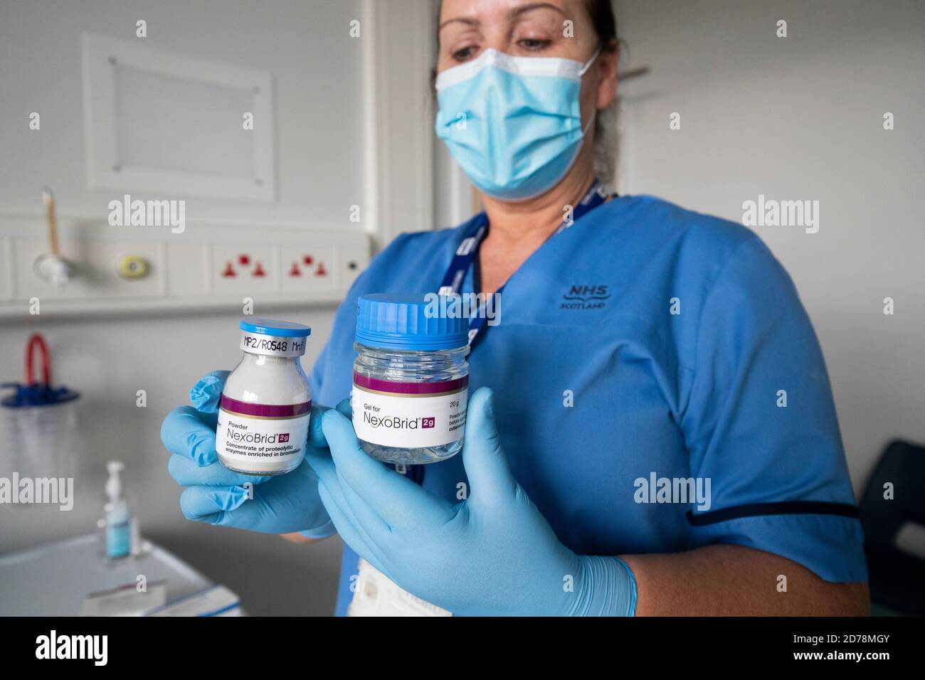 Nurse Isabelle Sweeny, at the burns unit at St John's Hospital, Livingston, holds jars of NexoBrid, a new treatment that uses enzymes extracted from pineapple plants to help remove the dead or burnt skin, leaving behind only healthy tissue in burns patients. Stock Photo
