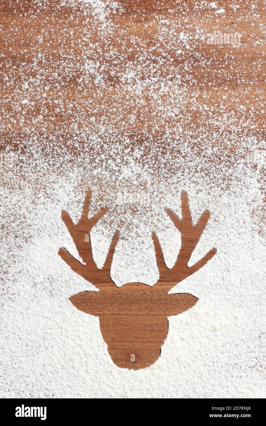 Christmas scene, reindeer head silhouette in wood and snow, copy space Stock Photo