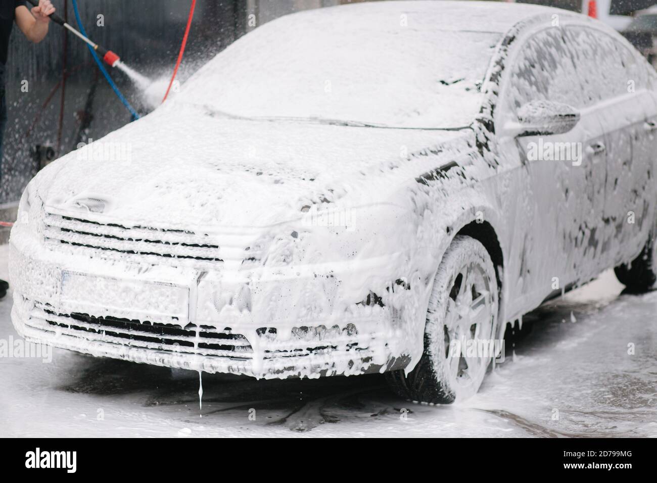 Cleaning car using active foam. Man washing his car on self car-washing  Stock Photo - Alamy