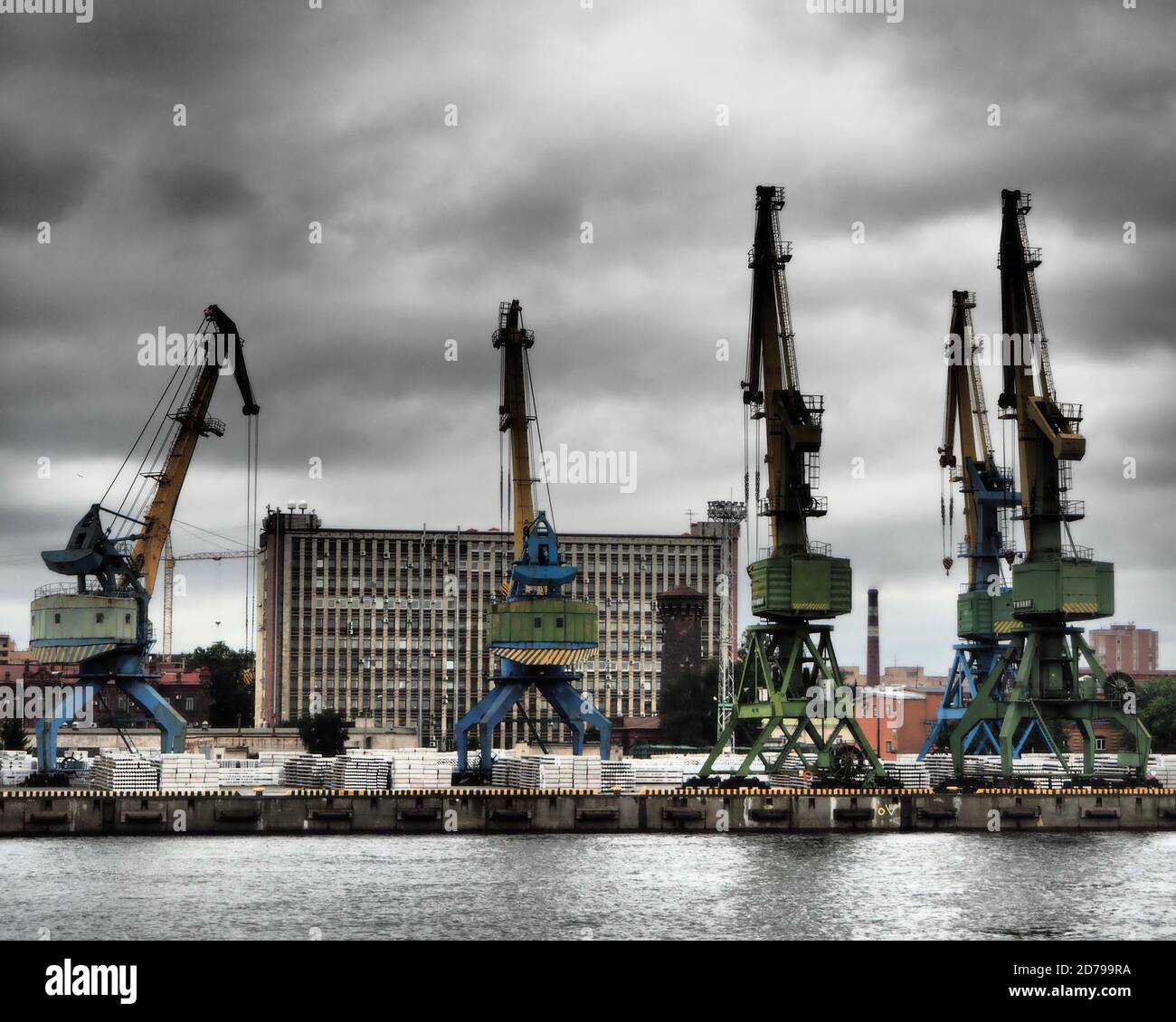 Cranes by riverside warehouses in St Petersburg, Russia Stock Photo