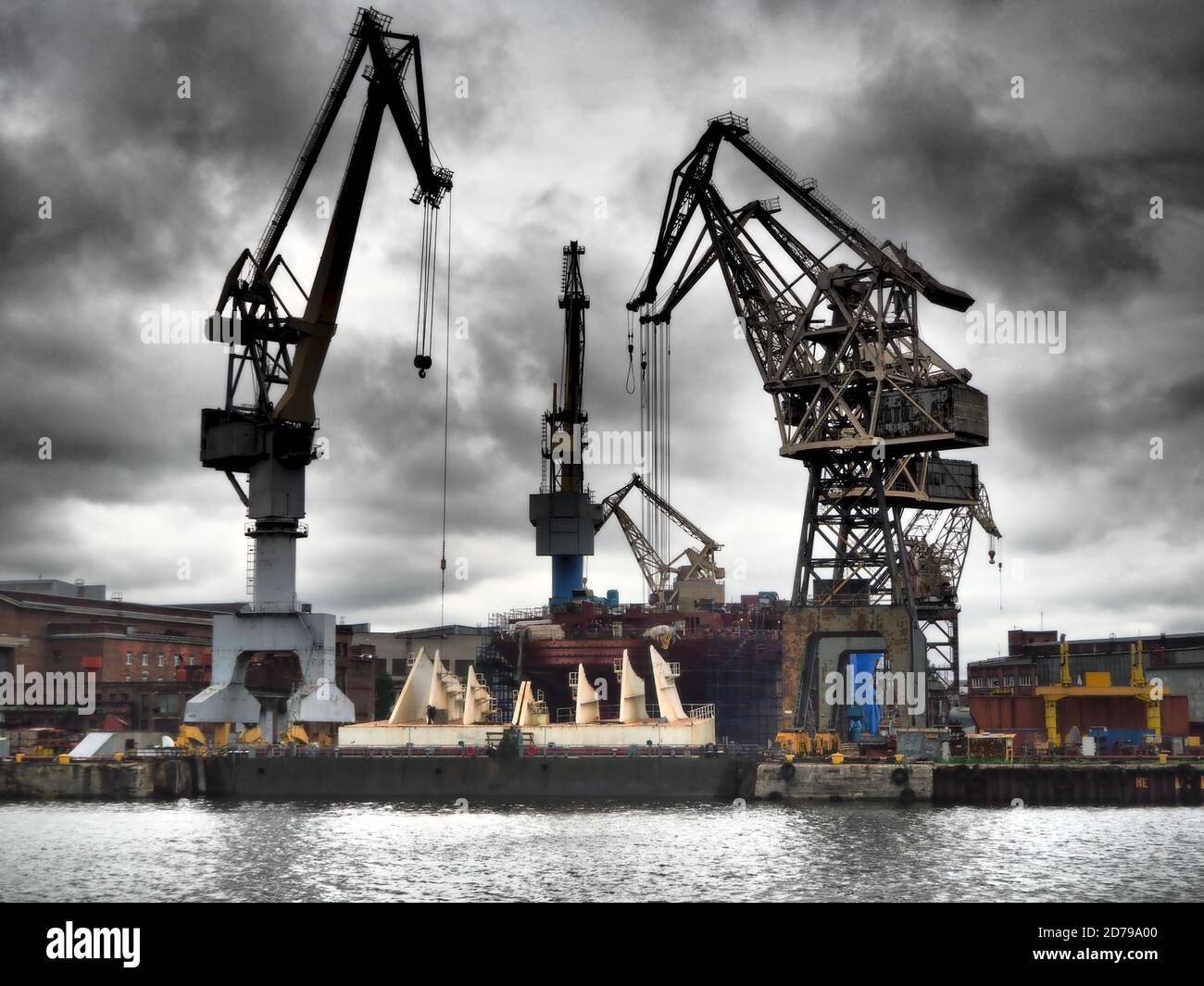 Cranes by riverside warehouses in St Petersburg, Russia Stock Photo