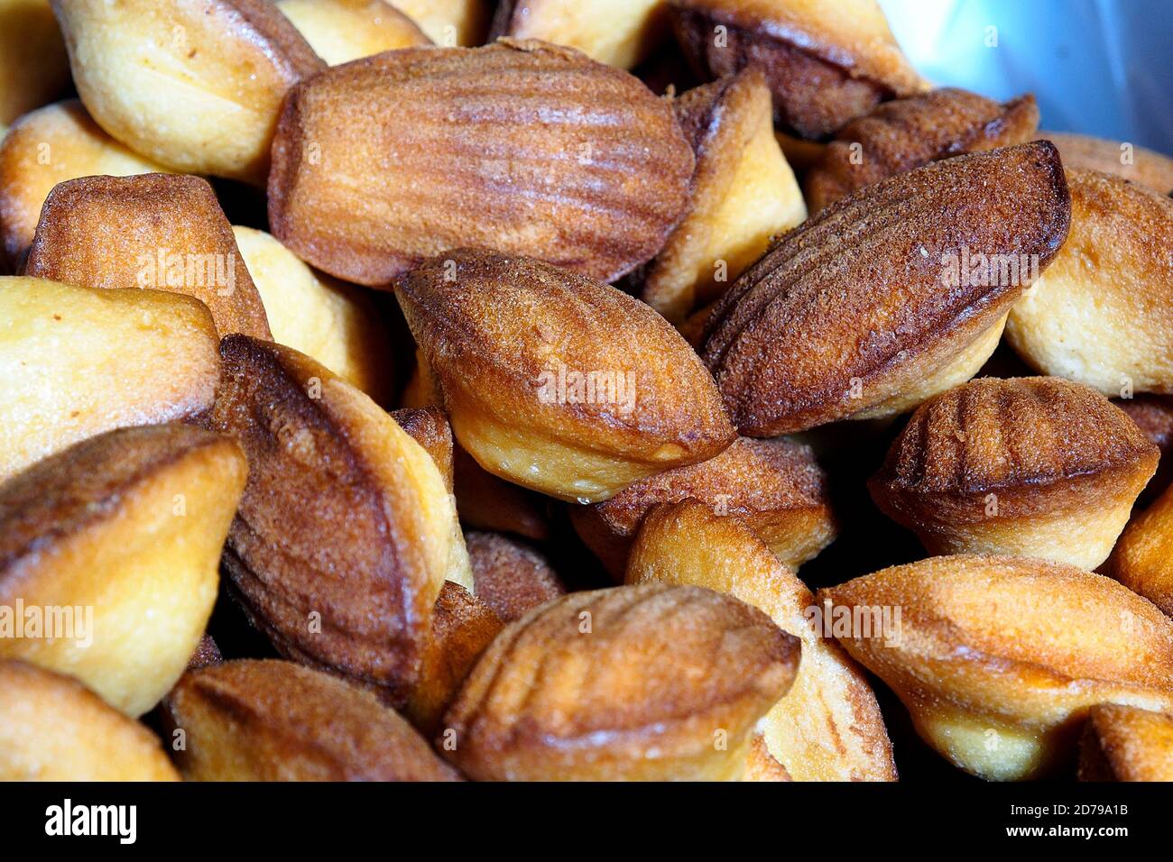 Food. Madeleine cookies on a stand in the street food market. Stock Photo