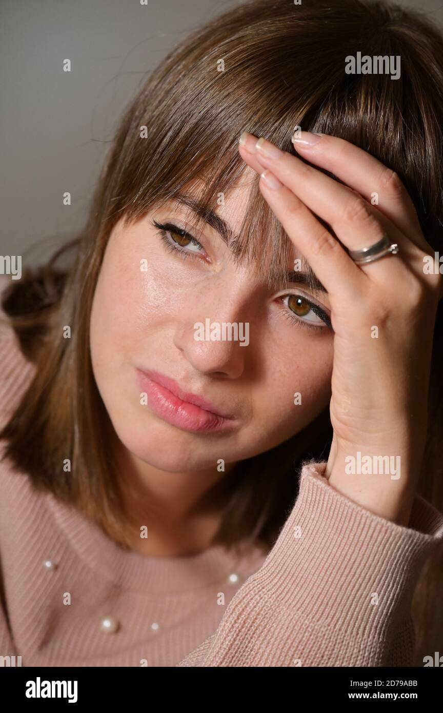 Exhausted Young Woman Has Suffering From Headache Stock Photo