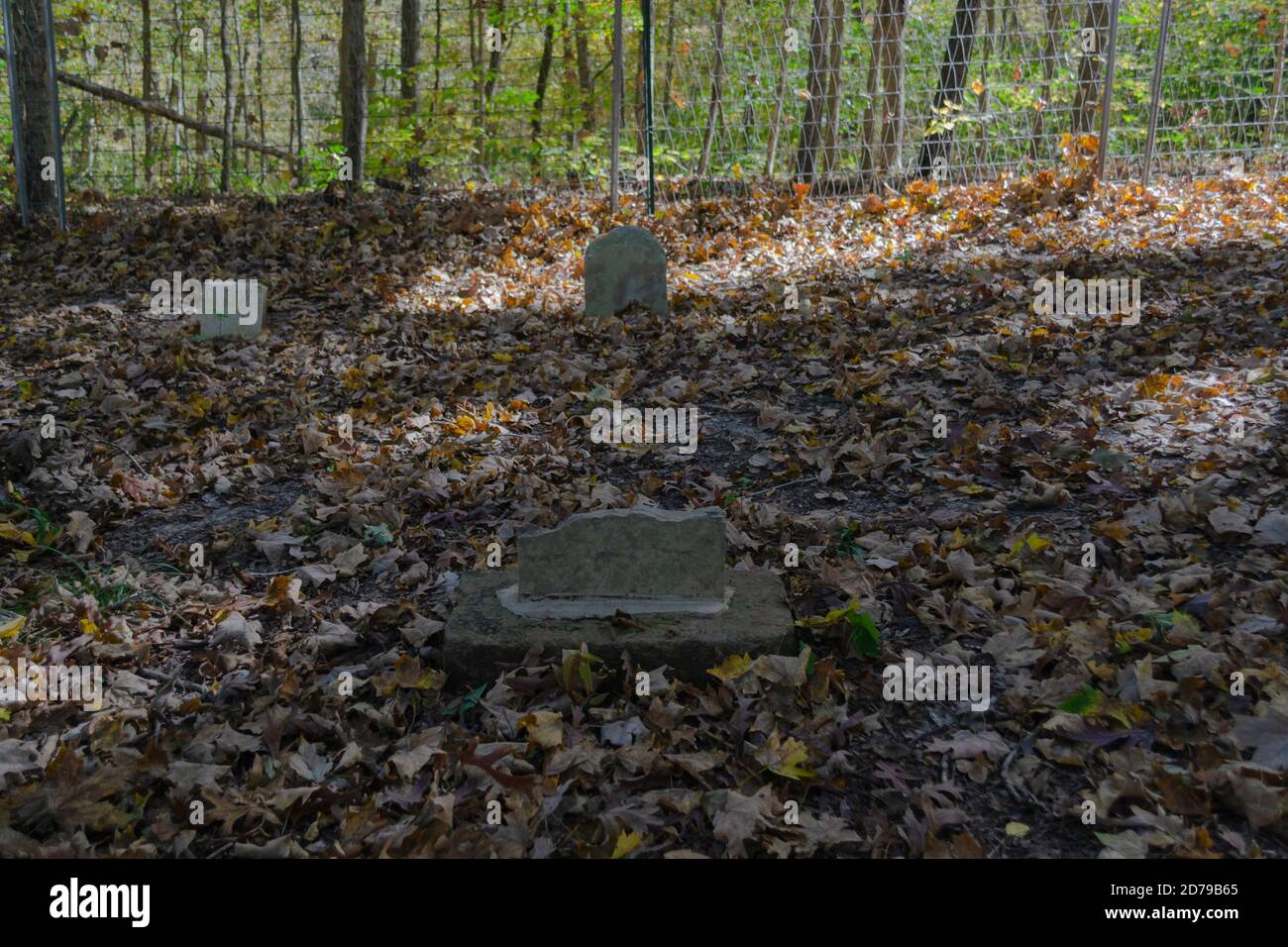 Broken tombstone in a small country graveyard Stock Photo