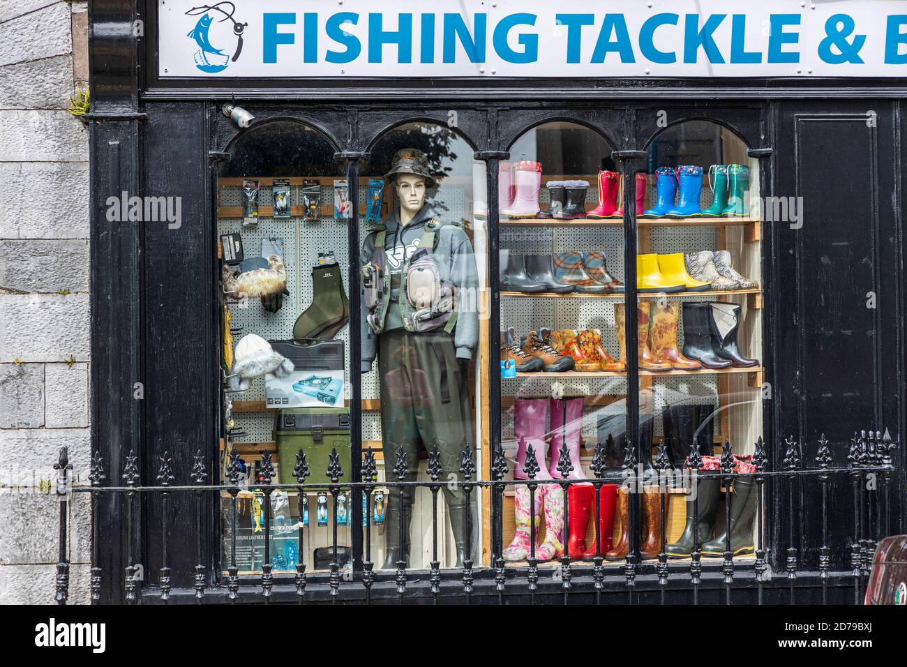 Old fashioned shopfront, display window of sishing wear, coloured welly boots and a manequin, Mallow, County Cork, Ireland Stock Photo