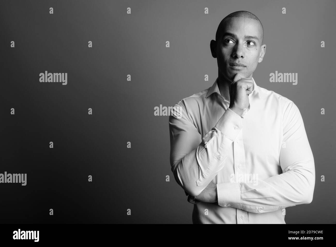 Portrait of handsome bald businessman against gray background Stock Photo